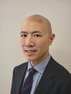 Derrick Lau wearing a suit and tie
